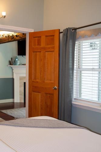 a bedroom with a bed and a wooden door at Hartstone Inn in Camden