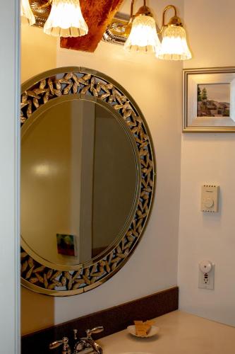 a bathroom with a large mirror on the wall at Hartstone Inn in Camden