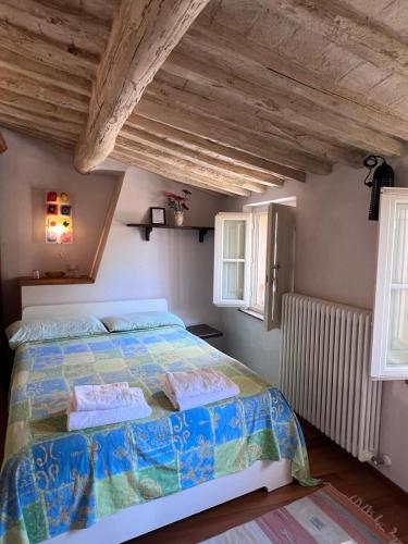 a bedroom with a large bed and two windows at da Francesco rooms in Lucca