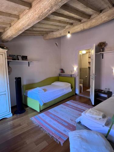a bedroom with two beds and a rug at da Francesco rooms in Lucca