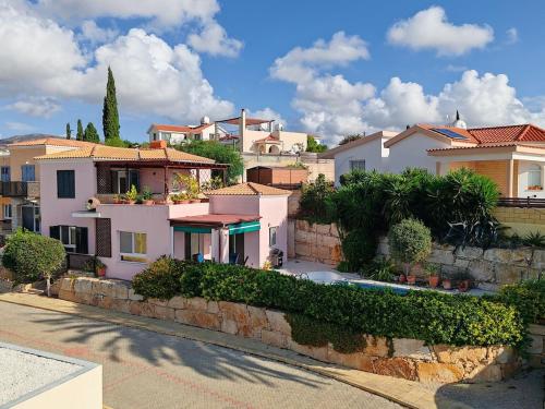 a group of houses on the side of a hill at Pink Villa in Peyia