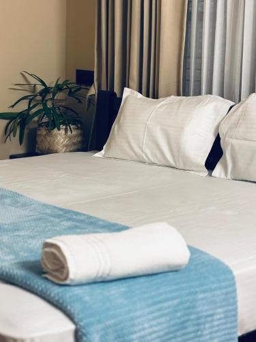 a white towel is laying on a bed at Venice villa varkala cliff -luxurious rooms and apartments in Varkala