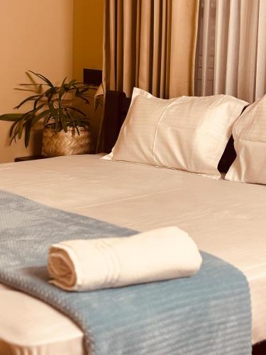 a towel is laying on a bed in a room at Venice villa varkala cliff -luxurious rooms and apartments in Varkala