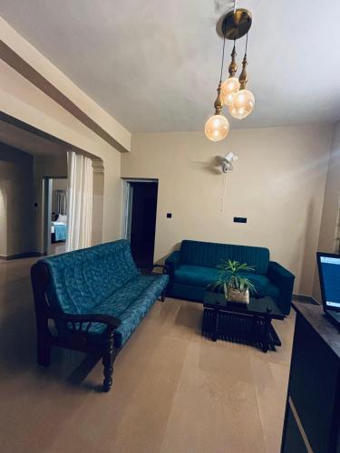 a living room with a green couch and a table at Venice villa varkala cliff -luxurious rooms and apartments in Varkala