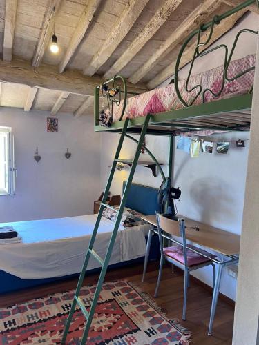 a room with a bunk bed and a desk and a bunk bed at da Francesco rooms in Lucca