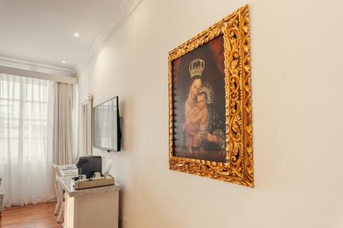 a painting hanging on a wall in a room at Hotel Boutique Santa Lucia in Cuenca