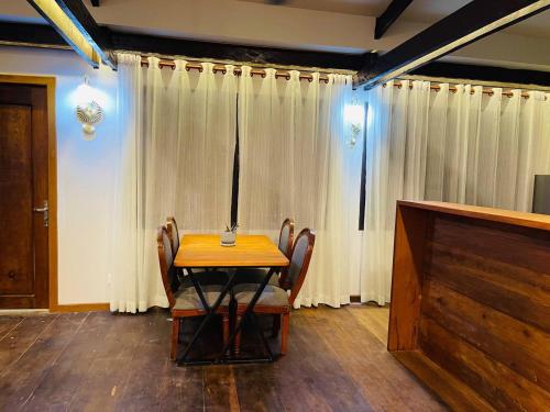 a dining room with a table and chairs and a television at Roya Khmer Homestay in Siem Reap