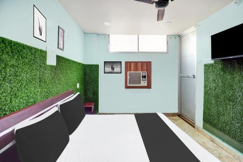 a conference room with green plants on the walls at Super Hotel O CITY HEIGHTS in Dhanbād