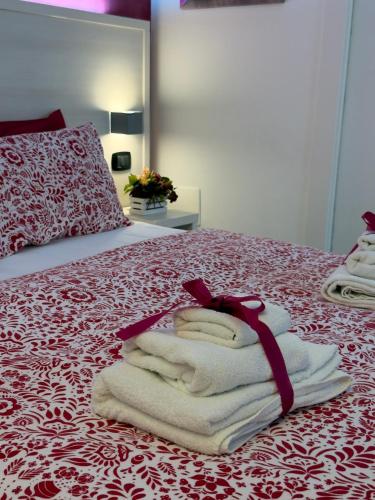 a pile of towels sitting on top of a bed at BelSorrisoVarese - Elegance City Residence Private Parking -Reservation Required- in Varese
