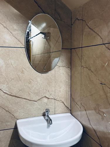 a bathroom with a sink and a mirror on the wall at Venice villa varkala cliff -luxurious rooms and apartments in Varkala
