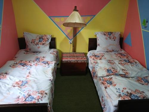 Una cama o camas en una habitación de Rossi Rest House