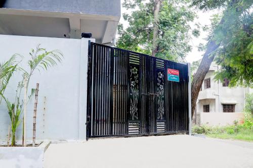 a black gate on the side of a building at Super Hotel O Sunshine Palace in Nagpur