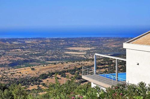 a house with a balcony on the side of it at Villa Zenit in Pozzallo