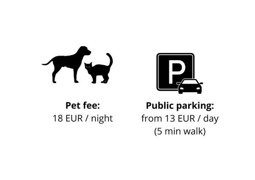 a dog and a cat are standing next to a parking sign at Hotel Barbakan in Český Krumlov