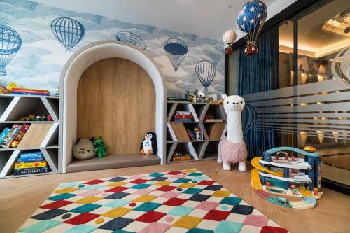 a childs room with a mural of hot air balloons at Wings Plaza in Kraków