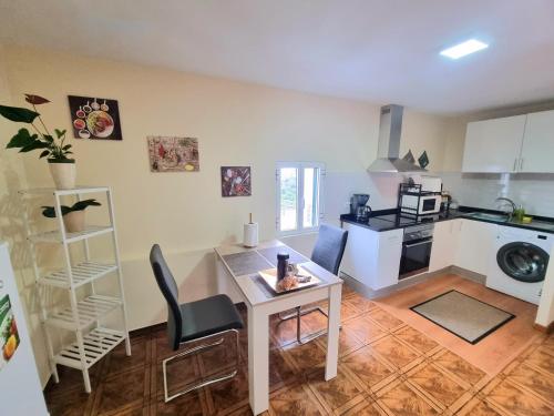 a living room with a table and a kitchen at Santana Madeira Hiking Getaway near Pico Ruivo and Levadas Base in Santana