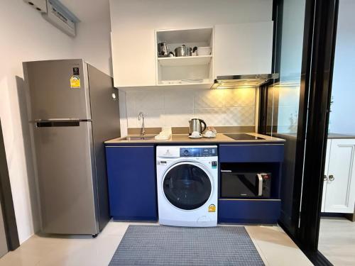a kitchen with a washing machine in the middle at Luxury Resort Style 1 Bedroom Studio near Central in Phuket