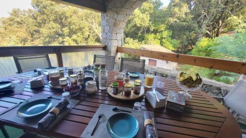 a wooden table with food on it on a balcony at DOMAINE CARDU in Cardo-Torgia