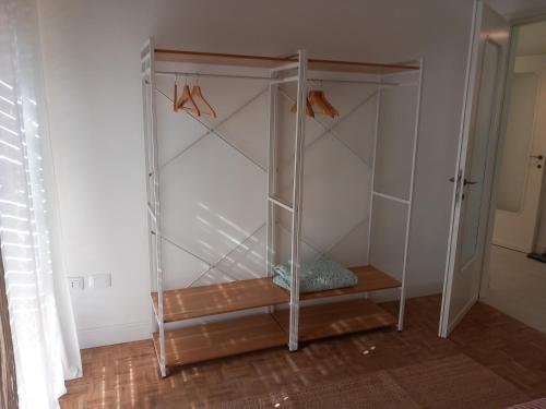 a glass cabinet with hangers in a room at Lorimare in Marina di Massa