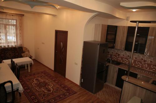 a living room with a refrigerator and a kitchen at Jermuk Apartment in the Center in Jermuk
