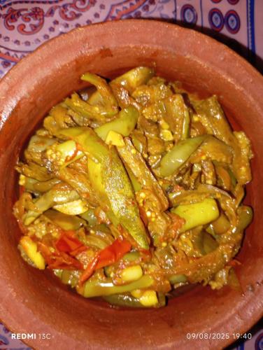 a brown bowl of food with vegetables in it at Villu Villa in Anuradhapura