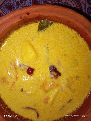a bowl of soup with a smiley face in it at Villu Villa in Anuradhapura