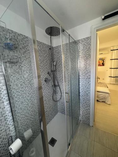 a bathroom with a shower with a glass enclosure at Flat in Duomo in Milan