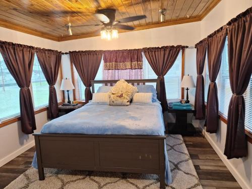 a bedroom with a bed in a room with windows at Entire Home 3BR 1BA Sleeps 6 St Pete, FL Spacious Private Backyard in St Petersburg
