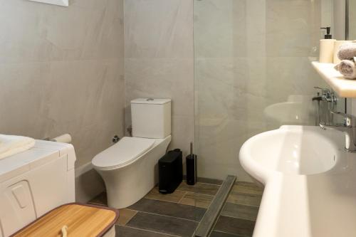 a bathroom with a toilet and a sink at Aristoteluos By the Sea in Thessaloniki