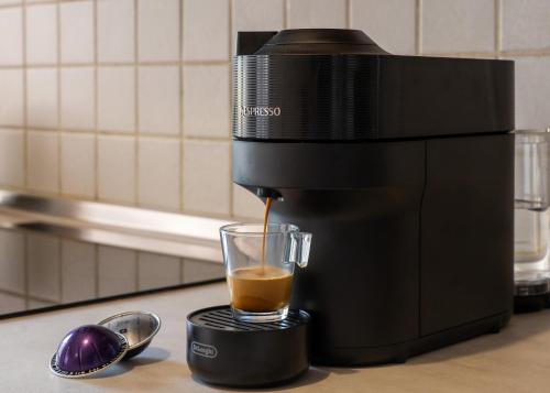 a coffee maker is making a cup of coffee at Aristoteluos By the Sea in Thessaloniki