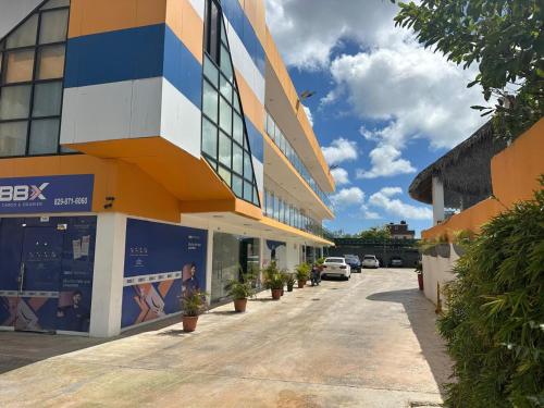 a building with cars parked in a parking lot at Sun express hotel in Punta Cana