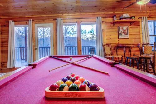 a pool table in the middle of a room at All Ya Need cabin in Seaton Spring
