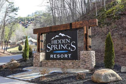 a sign for a hidden springs resort on a road at All Ya Need cabin in Seaton Spring