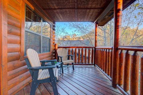 two chairs sitting on the porch of a cabin at All Ya Need cabin in Seaton Spring