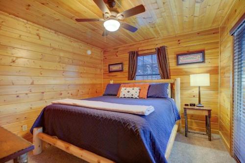 a bedroom with a bed in a log cabin at All Ya Need cabin in Seaton Spring