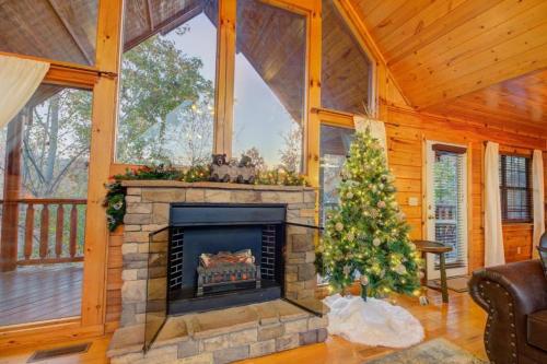 a living room with a fireplace and a christmas tree at All Ya Need cabin in Seaton Spring