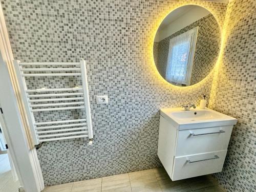 a bathroom with a sink and a mirror at Flat in Duomo in Milan