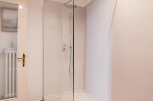 a shower with a glass door in a bathroom at Victoria Palace in Salò