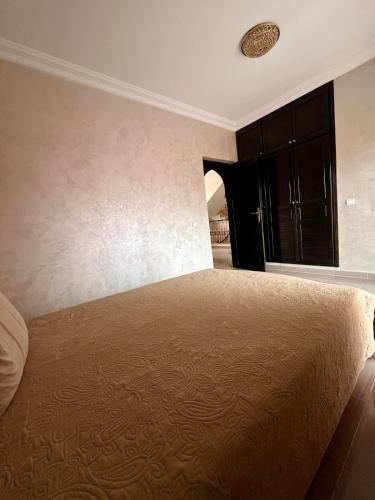 a bedroom with a large bed in a room at Villa with private pool in Tamensourt