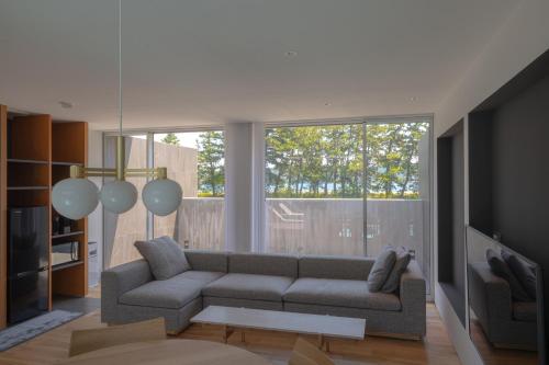 a living room with a couch and a large window at Villa NIGIN in Miyazu