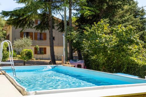 a swimming pool in front of a house at Italian Experience-La Pineta Holiday Homes in Monte Fabbri