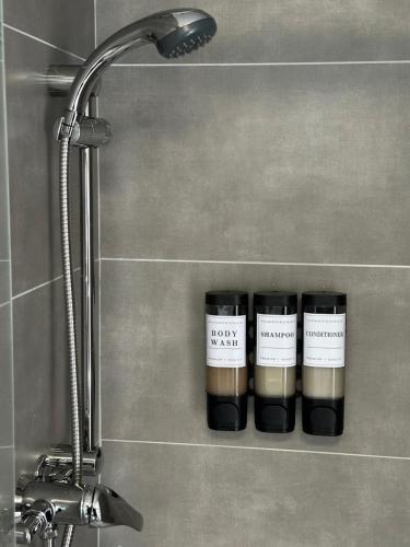 three candles sitting on a shelf in a bathroom at Brand New Studio Flat 36 in Dublin