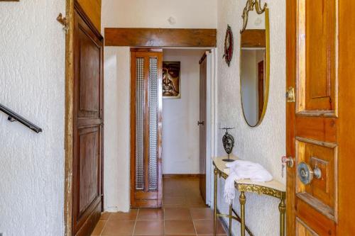 a bathroom with a sink and a mirror and a door at Italian Experience-La Pineta Holiday Homes in Monte Fabbri