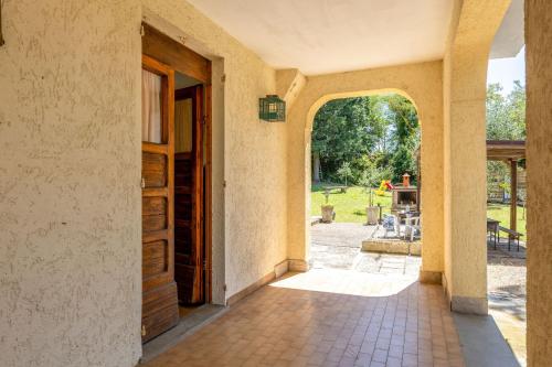 an entrance to a house with an open door at Italian Experience-La Pineta Holiday Homes in Monte Fabbri