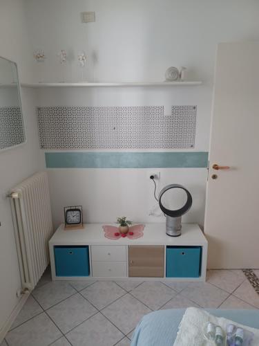 a room with a bed and a table with a mortar at Maison Prestige in Monfalcone
