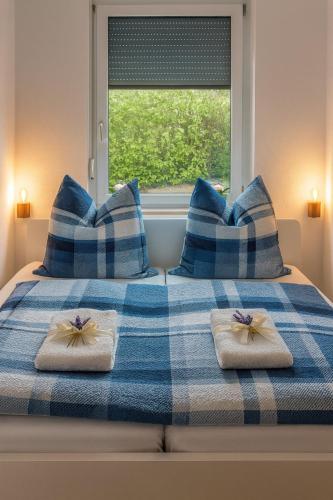 a blue and white bed with blue and white pillows at Seeblick in Daisendorf