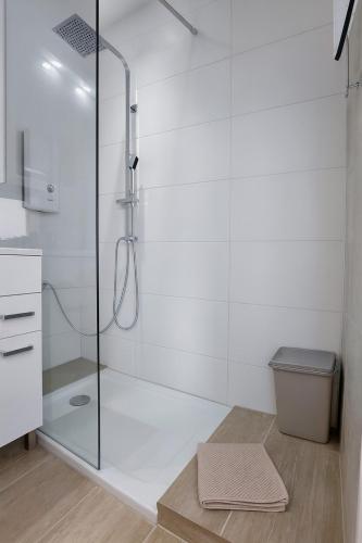 a bathroom with a glass shower with a toilet at Seeblick in Daisendorf