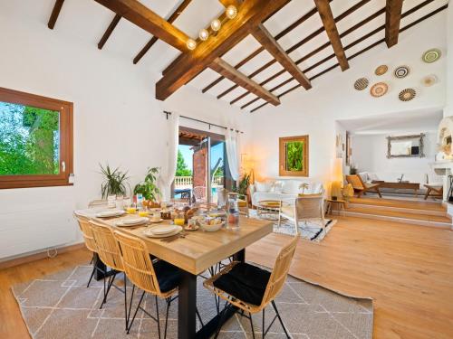 a dining room with a large wooden table and chairs at Villa Horizon - 5min from Monaco - Panoramic view - Infinity Pool - Air conditionner - Garden - Parking - Premium Services - Near Monaco Events in Fontvieille