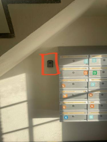 a drawer in a wall with a red box on it at Central apartment with parking and Netflix in Aarhus