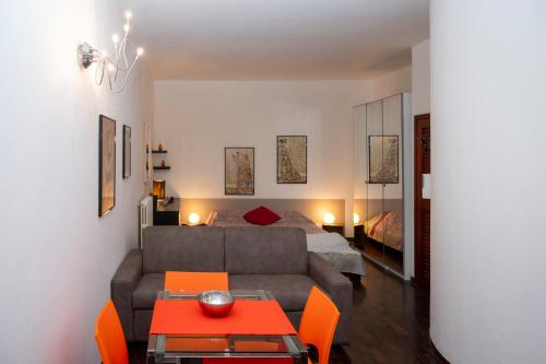 a living room with a couch and a bed at Casa di Flo - Medieval City Centre with WiFi & AC in Ferrara